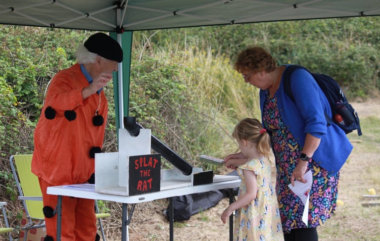 Little girl and adult playing Splat the Rat game