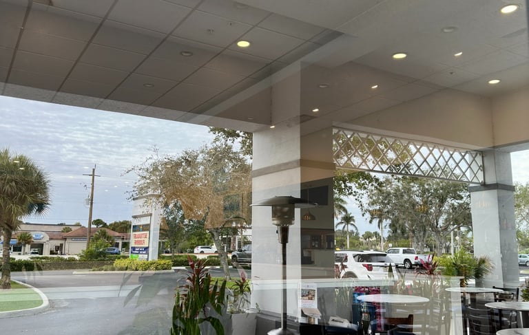 Commercial window cleaning services for a business storefront and patio in Naples, Florida.