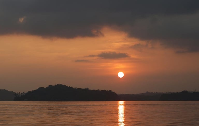 Andaman trip details - A soulful sunset view over the quiet coastal silhouette and shimmering waters