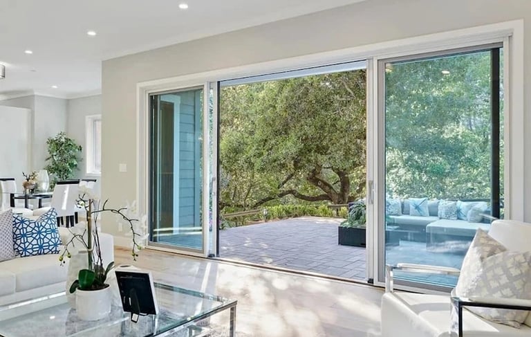 Living area with sliding glass doors opening to an outdoor deck.
