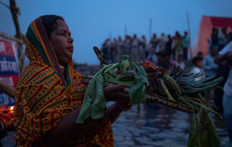 A woman in a colorful dress holding a basket of vegetables during Chhath festival
