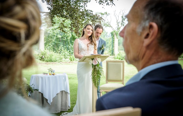 a man and woman standing in front of a table