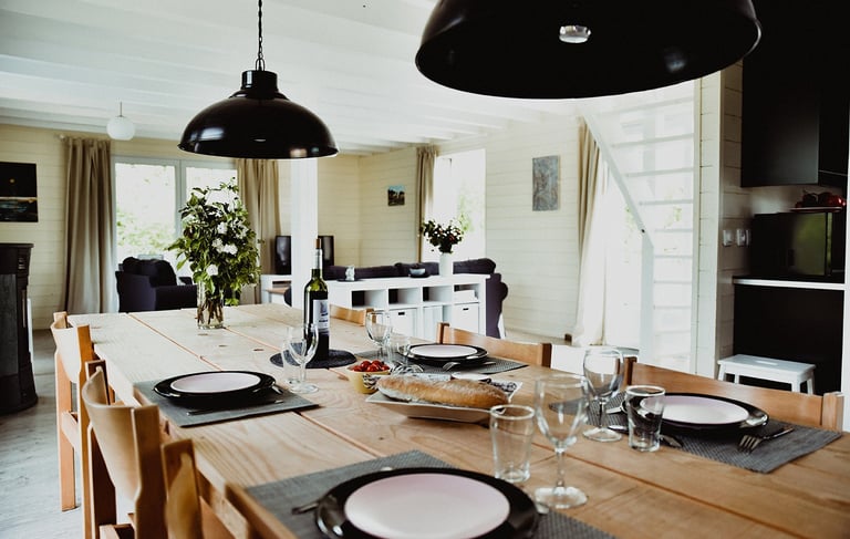 a dining room table with plates and glasses Maison Les Terrasses
