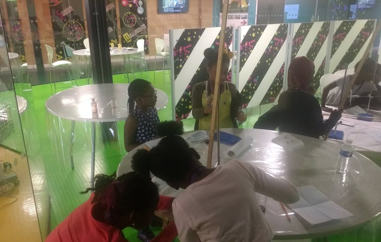 a group of girls doing science experiments