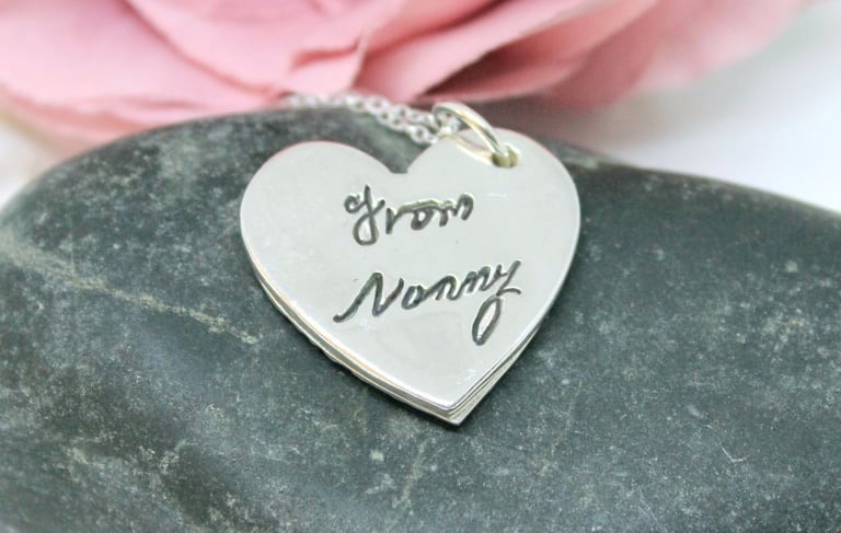 Silver memorial jewellery with a heart pendant and a loved one's real handwriting.