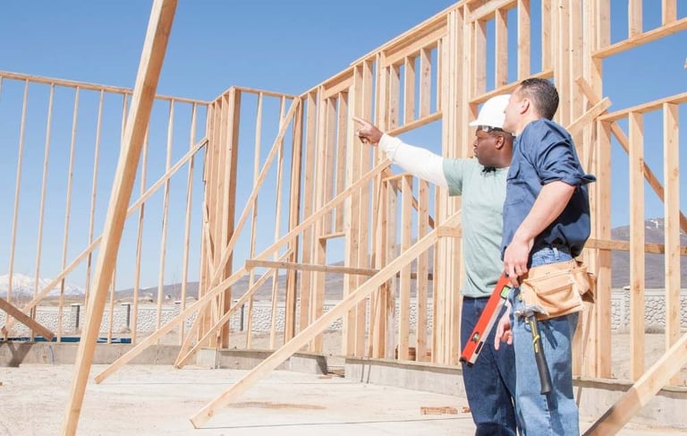 a man in a construction site with a construction worker