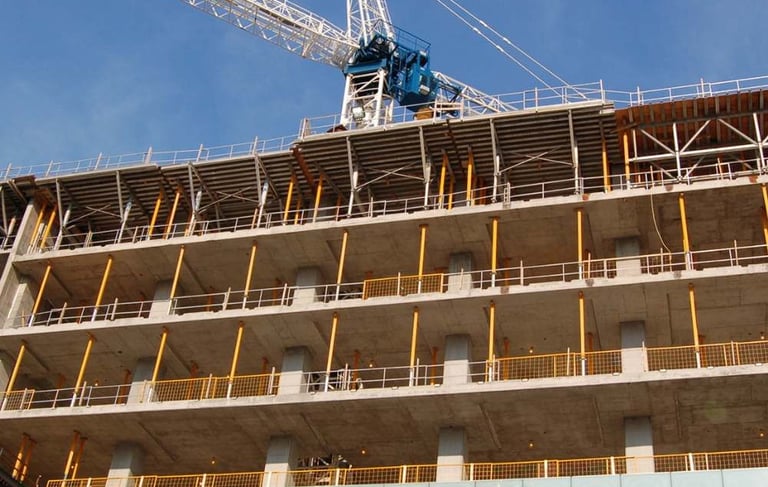 a crane is standing in front of a building
