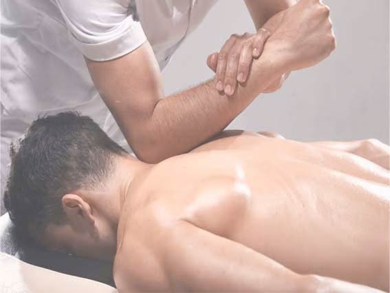 Male having a remedial massage treatment on his back, with strong elbow pressure