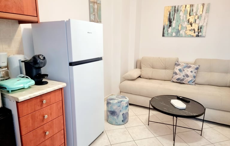 a kitchen and living room with a couch and coffee table