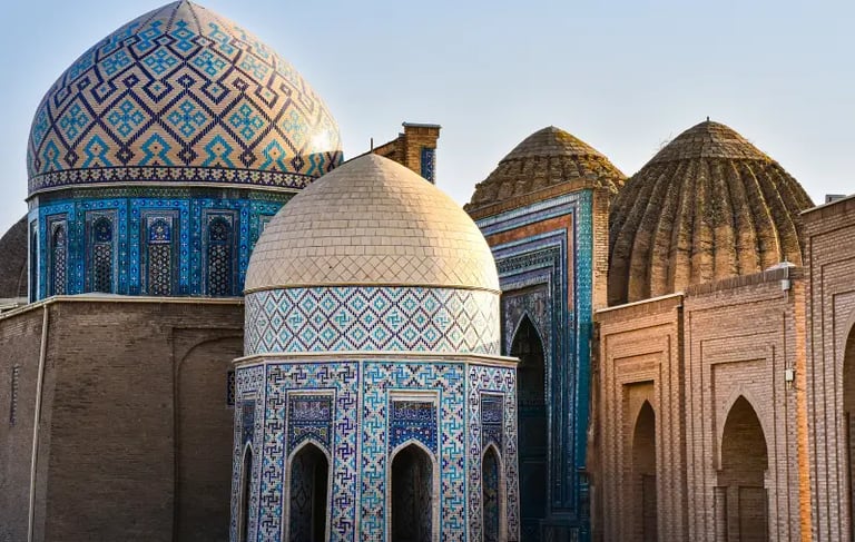 Ornate blue tiled domes and ancient Islamic architecture at the Shah-i-Zinda necropolis in Samarkand, Uzbekistan.