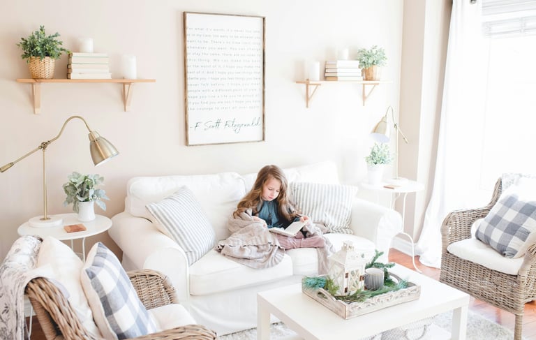 girl reading in a paceful white sofa