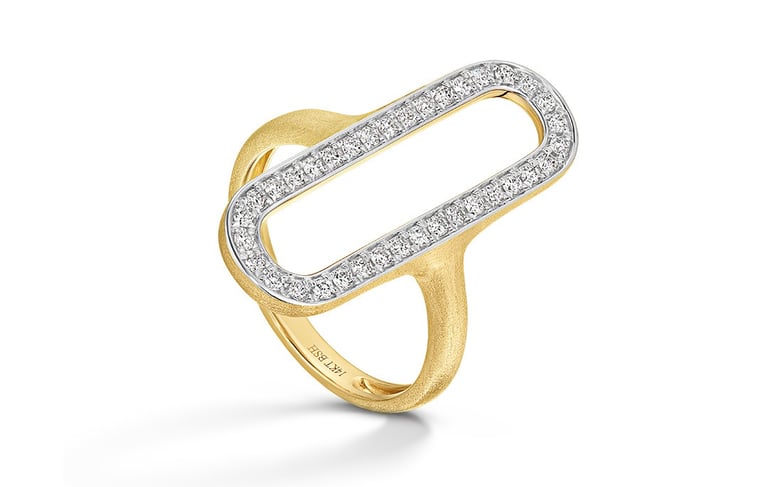 Modern gold ring with open oval shape, outlined in white metal and encrusted with diamonds, on white background