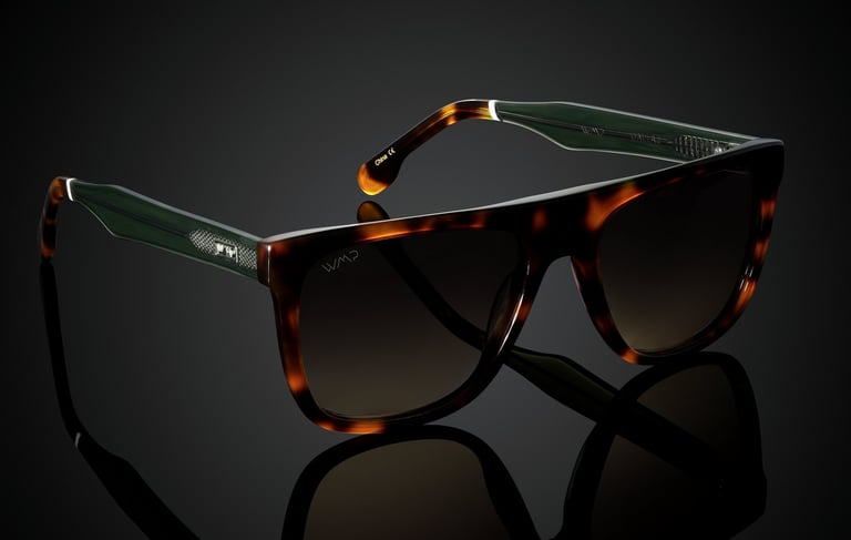 Tortoiseshell sunglasses with green accents and brown lenses, displayed on a reflective black background for e-commerce photo