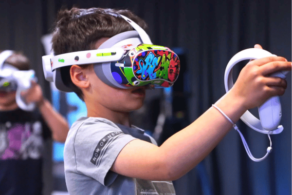 A boy in a vr headset with a video game controller