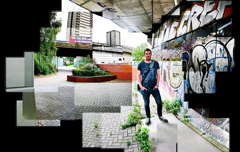 A joiner of a man standing in an urban environment with a graffiti sprayed wall over his shoulder