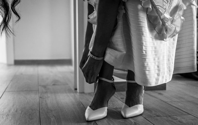 a woman in a dress and heels is standing in a room