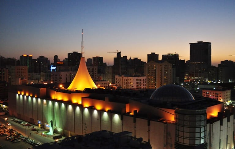 a city skyline at night time with a church and a church steeple