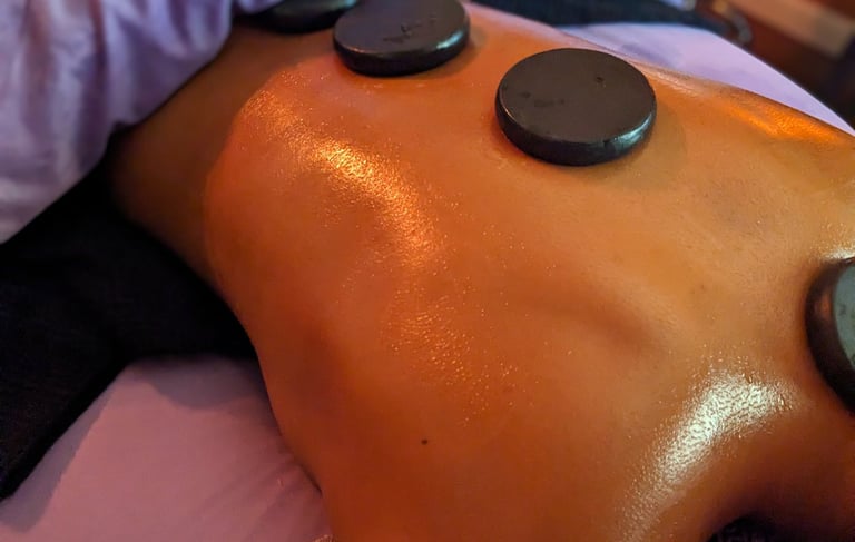 hot stones laying on aback during a massage