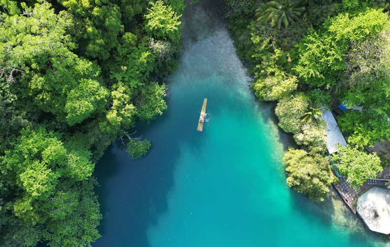 a boat floating in blue lagoon, jamaica