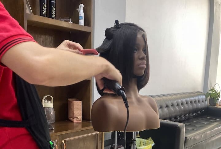 Stylist finishing a Vietnamese human hair bob wig at Vietsilkhair.