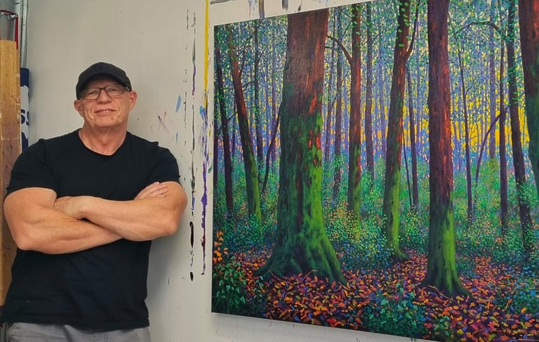Kevin McKeown chromatic impressionist artist in the studio with a completed oil painting