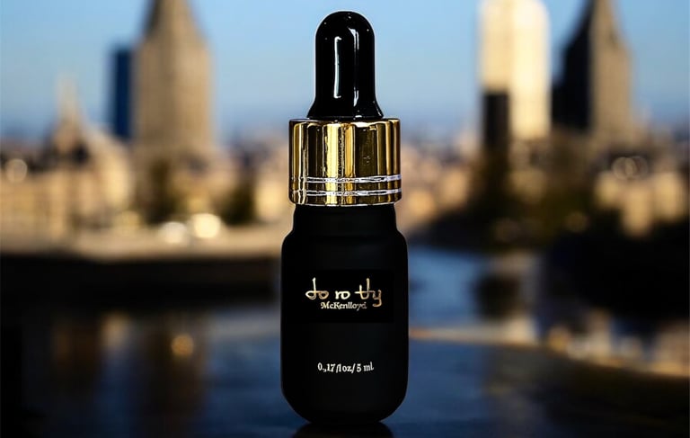 a bottle of perfume on a table with a city in the background