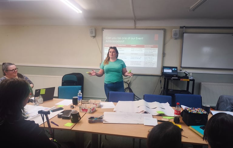 a woman in a green shirt is standing in front of a group of people