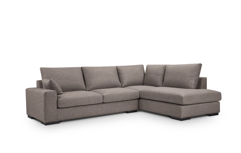 a couch with a chaisette and pillows