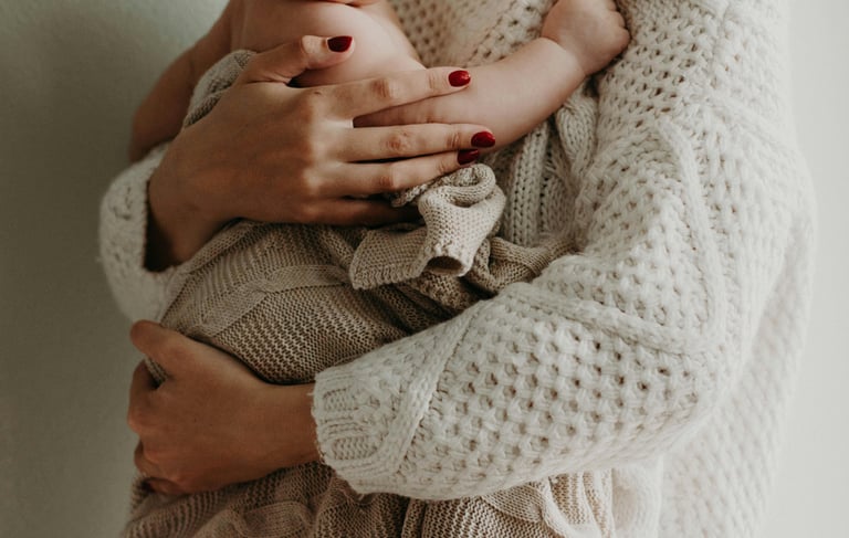 a woman holding a baby in her arms