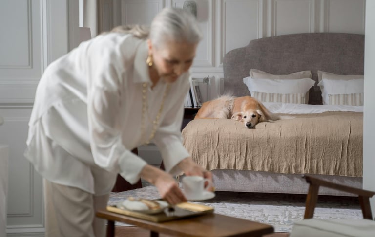 a woman in a white shirt and a dog on a bed