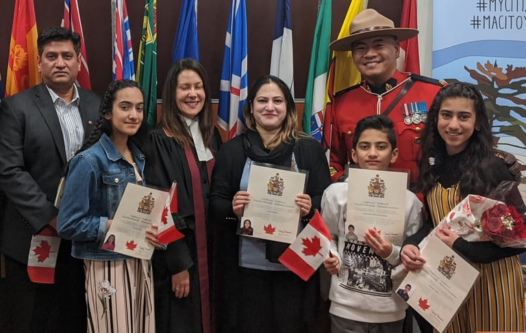 a happy family TWC Financial client standing in front of a Canadian flag