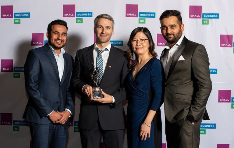 a group of people standing around a man in a suit, TWC Financial clients