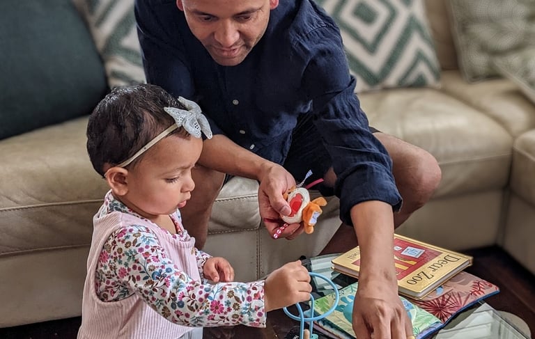 Little girl and father playing with toys
