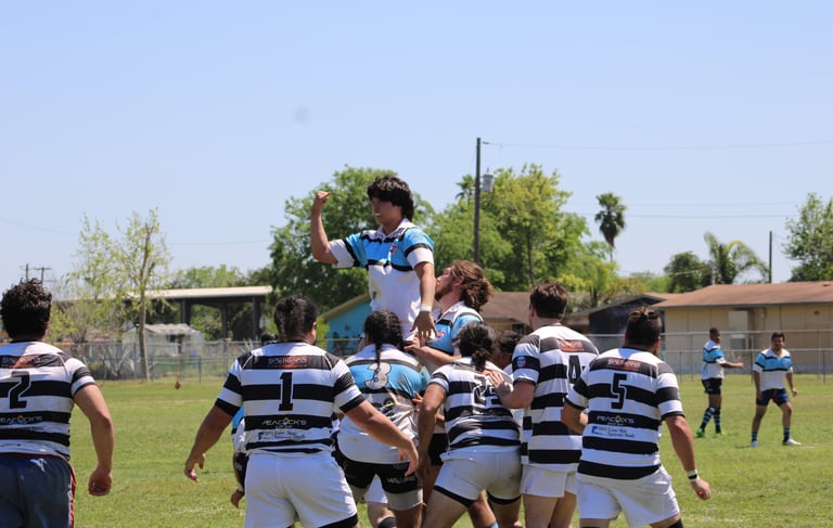 a group of men playing rugby in a field