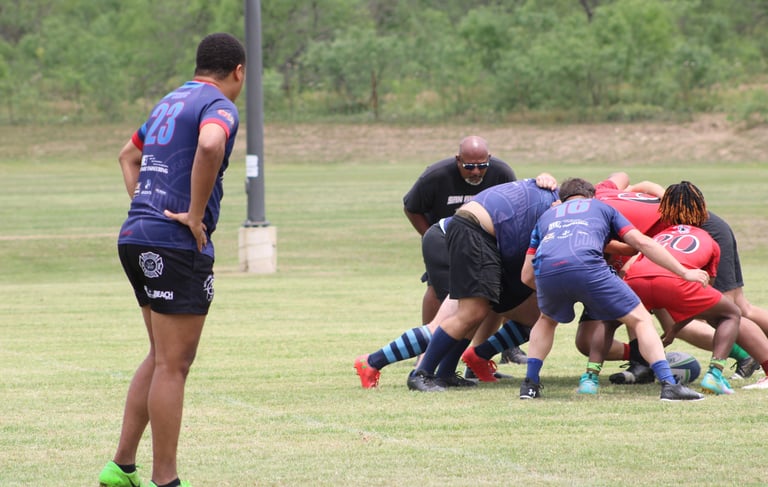 a group of men playing rugby in a field