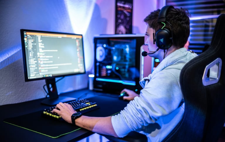 Person gaming at a desk on a computer using Discord, with a digital-themed background, representing 