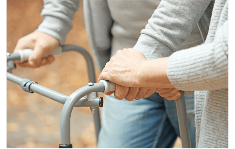 a woman holding a walker frame in her hands
