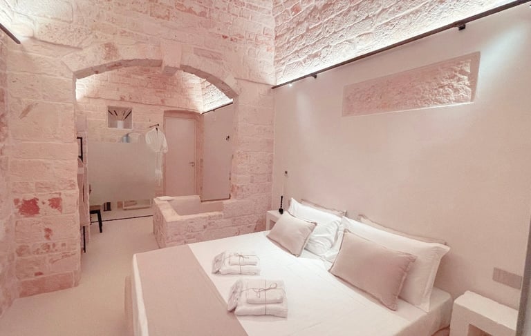 a bedroom with a bed and a bathtub