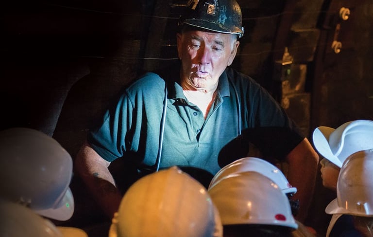 a welsh miner chatting to visitors