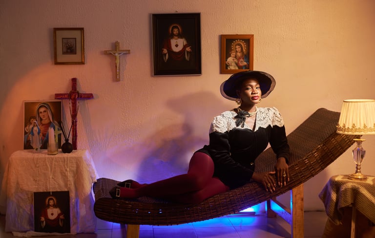 a black woman in a hat and a hat on a chaise lounge chair in a vintage house with a Catholic altar