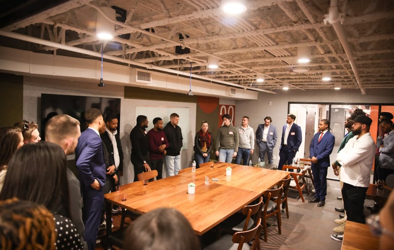 Professionals engaging in discussions at a Bridge City Connections networking event in Pittsburgh.