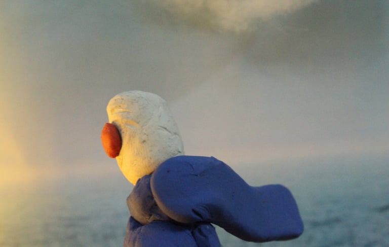 a stuffed animal is sitting on a rock