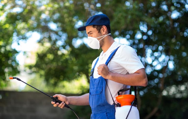 a man wearing mask working in pest control
