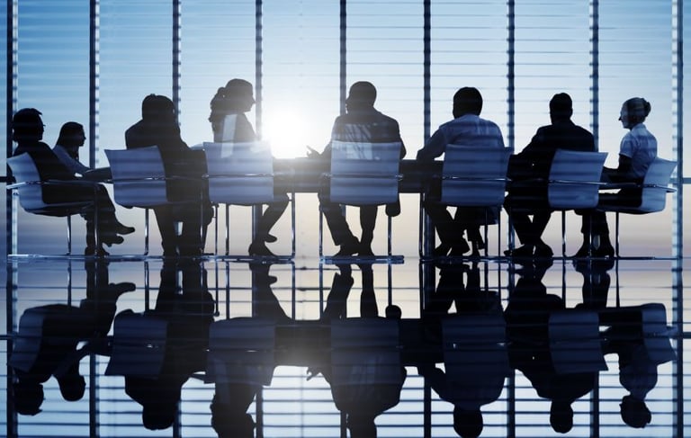 a group of people sitting around a table