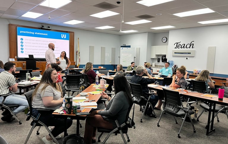 Educators collaborating in a professional development workshop classroom.