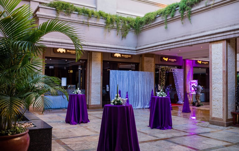 foyer of corporate event with high top tables and floral center pieces