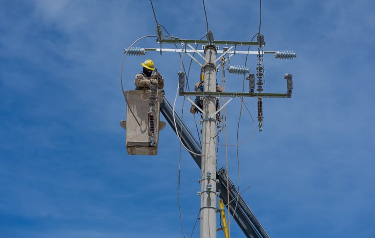 a man in a hard hat working on a pole