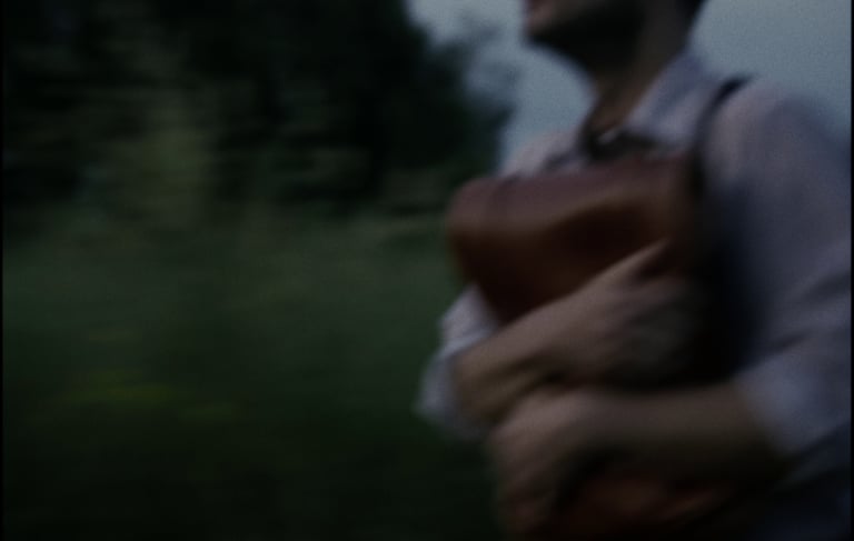 a man in a leather vest with a leather vest