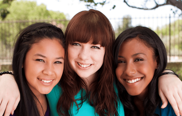 Smiling faces of diversity in the energizeHER Village for Girls membership