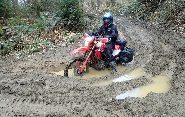 a person riding a dirt bike in the mud